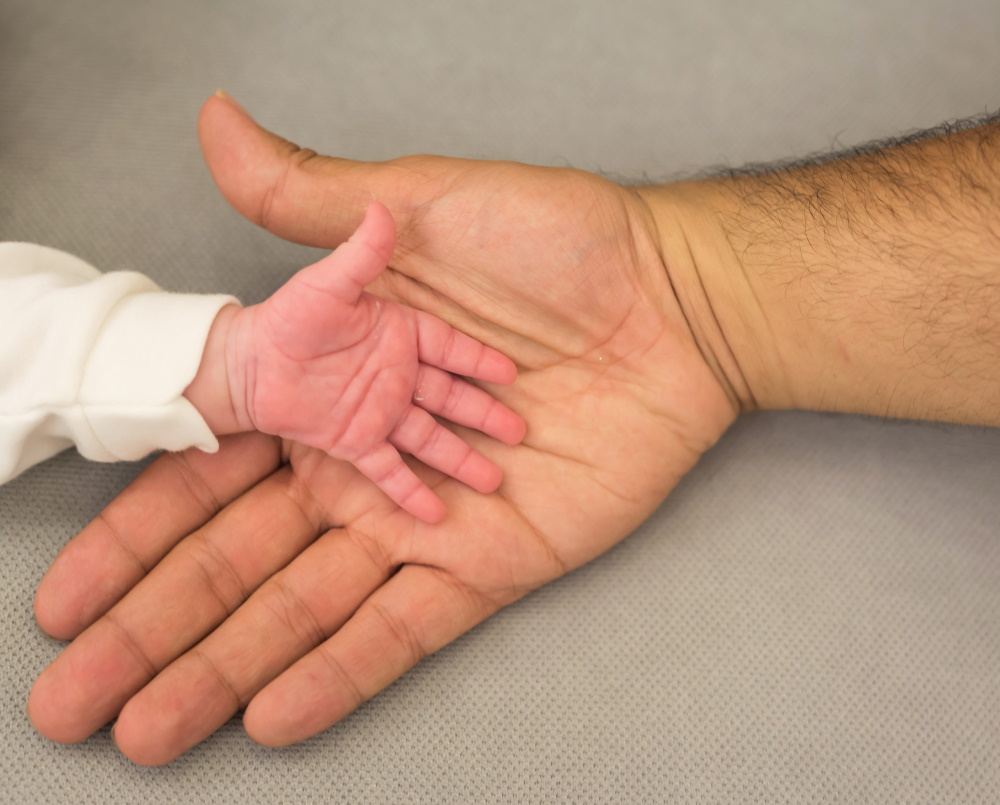 dad's hand with baby hand